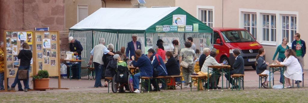 Blick auf den Informationsstand des Vereins mit Verpflegungszelt (links Informationstafel zur Arbeit des Vereins in Afrika).