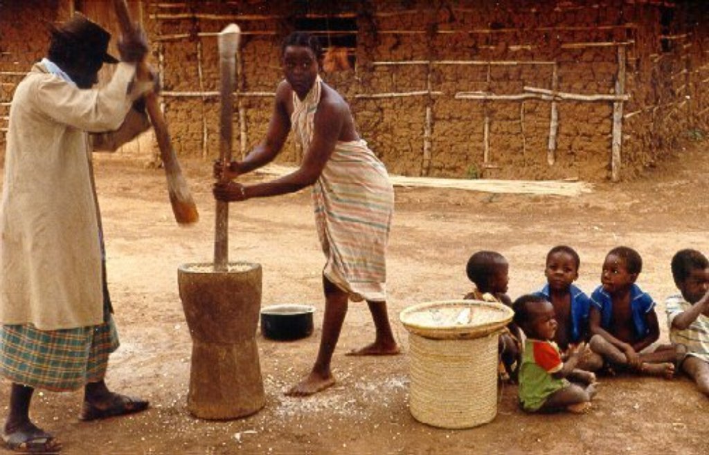 These residents of Kulesa are crushing corn using a traditional mortar-and-pestle-type corn mill.